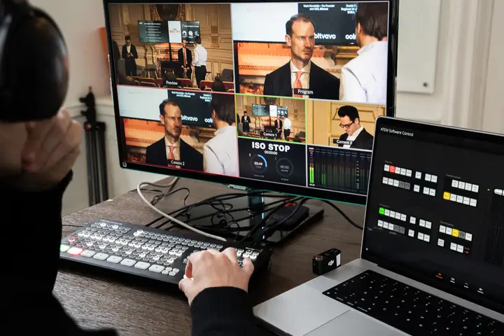 A live-production control desk with camera feeds and a video switcher.