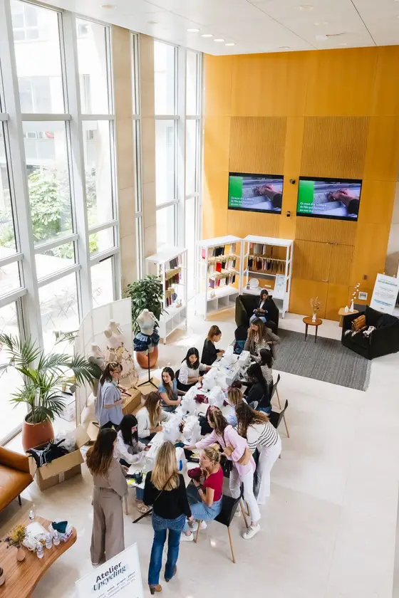 People gathered around a table in a bright, open office.