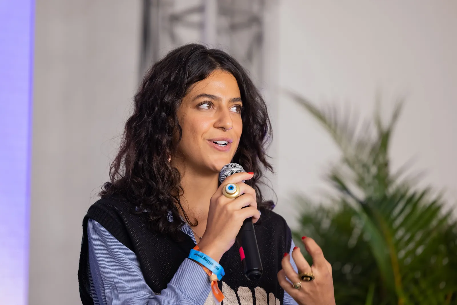A speaker mid-gesture while addressing the room.